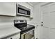 Modern kitchen featuring stainless steel appliances and sleek countertops at 5053 Lofton Dr, New Port Richey, FL 34652