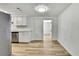 Bright kitchen area with stainless steel appliances, white cabinets, and light wood flooring at 5053 Lofton Dr, New Port Richey, FL 34652