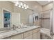 Bright bathroom boasts double sinks, granite counters, and a shower/tub combo at 510 33Rd N Ave, St Petersburg, FL 33704