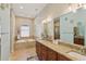 Bathroom featuring double sinks with granite countertops, a soaking tub, and a separate shower at 510 33Rd N Ave, St Petersburg, FL 33704