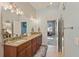 Bathroom with double sinks, granite countertops, framed mirrors, and a view into an adjacent bedroom at 510 33Rd N Ave, St Petersburg, FL 33704