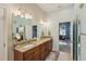 Bathroom with double sinks, granite countertops, framed mirrors, and a view into an adjacent bedroom at 510 33Rd N Ave, St Petersburg, FL 33704