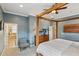 Stylish bedroom with a four-poster bed, ceiling fan, and en-suite bathroom with a soaking tub at 510 33Rd N Ave, St Petersburg, FL 33704