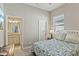 Bedroom with blue accents and doorway to adjoining bathroom at 510 33Rd N Ave, St Petersburg, FL 33704
