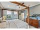 Spacious bedroom with a wooden four-poster bed, dresser, ceiling fan, and calming blue walls at 510 33Rd N Ave, St Petersburg, FL 33704