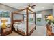 Bedroom featuring a four-poster bed, ceiling fan, and natural light streaming through the windows at 510 33Rd N Ave, St Petersburg, FL 33704