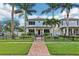 Charming two-story home with manicured lawn, mature palms, and a decorative fence at 510 33Rd N Ave, St Petersburg, FL 33704