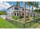 Beautiful home exterior featuring well-manicured landscaping and a wrought iron fence at 510 33Rd N Ave, St Petersburg, FL 33704