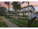 Stylish two-story home featuring manicured landscaping and fenced yard, seen at dusk at 510 33Rd N Ave, St Petersburg, FL 33704