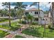 Stunning two-story home with lush landscaping, palm trees, and a charming brick walkway at 510 33Rd N Ave, St Petersburg, FL 33704