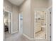 Neutral hallway with carpet and doorways leading to a bedroom and a bathroom with white cabinetry at 510 33Rd N Ave, St Petersburg, FL 33704