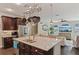 Open-concept kitchen features a granite island, stainless steel appliances and hanging pot rack at 510 33Rd N Ave, St Petersburg, FL 33704