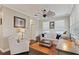 Cozy living room with a decorative ceiling fan, comfortable sofa, and a quaint writing desk at 510 33Rd N Ave, St Petersburg, FL 33704