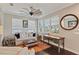 Bright living room with large windows, a comfortable sofa, and a quaint writing desk at 510 33Rd N Ave, St Petersburg, FL 33704