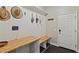 Charming mud room with custom built-in storage, wood counters, and unique wall decor at 510 33Rd N Ave, St Petersburg, FL 33704