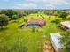 Expansive property featuring a private pool, verdant landscaping, and multiple structures at 5100 Lockhart Rd, Brooksville, FL 34602
