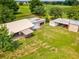 Aerial view of a property featuring outbuildings, sheds, and a spacious lawn at 5100 Lockhart Rd, Brooksville, FL 34602