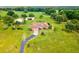 Aerial view of a single-story home on an expansive lot surrounded by trees at 5100 Lockhart Rd, Brooksville, FL 34602