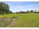 Expansive backyard featuring a screened-in pool and lots of green space at 5100 Lockhart Rd, Brooksville, FL 34602