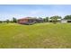 Expansive green backyard featuring a screened-in pool and additional structures at 5100 Lockhart Rd, Brooksville, FL 34602