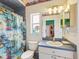 Cozy bathroom featuring a fish themed shower curtain, toilet, vanity, and window at 5100 Lockhart Rd, Brooksville, FL 34602