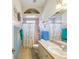 Hall bathroom features a single sink vanity and shower with seashell decor at 5100 Lockhart Rd, Brooksville, FL 34602