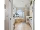Bright bathroom featuring dual sinks, a soaking tub with steps, and a glass-enclosed shower at 5100 Lockhart Rd, Brooksville, FL 34602