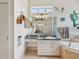 Stylish bathroom with tiled floors, mirrored wall, and updated vanity with marble countertops at 5100 Lockhart Rd, Brooksville, FL 34602