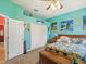 Bright bedroom with blue walls, tropical decor and a ceiling fan at 5100 Lockhart Rd, Brooksville, FL 34602
