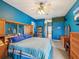 Spacious bedroom with blue walls, carpet floors, and a view to the bathroom hallway at 5100 Lockhart Rd, Brooksville, FL 34602