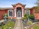 Front entrance showcases columns, arched windows and artful landscaping at 5100 Lockhart Rd, Brooksville, FL 34602