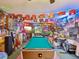 Eclectic game room featuring a pool table, racecar memorabilia, and custom neon lights creates a unique entertainment space at 5100 Lockhart Rd, Brooksville, FL 34602