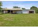Large metal building with multiple garage doors, perfect for storing equipment or vehicles at 5100 Lockhart Rd, Brooksville, FL 34602