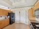 Bright kitchen with black appliances and overhead lighting at 5100 Lockhart Rd, Brooksville, FL 34602