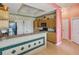 Kitchen featuring breakfast bar, drop ceiling with fan, and wooden cabinetry at 5100 Lockhart Rd, Brooksville, FL 34602