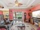 Spacious living room with hardwood floors, a fireplace, a ceiling fan, and a sliding glass door at 5100 Lockhart Rd, Brooksville, FL 34602