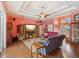 Inviting living room features hardwood floors, a fireplace, a ceiling fan, and an entryway with glass doors at 5100 Lockhart Rd, Brooksville, FL 34602