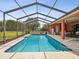 Screened-in pool area featuring pool, outdoor seating, and access to the home at 5100 Lockhart Rd, Brooksville, FL 34602