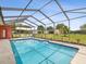 Relaxing pool with chairs and table with a view of the yard at 5100 Lockhart Rd, Brooksville, FL 34602