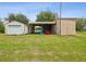 Outbuildings provide extra storage space on a large lawn at 5100 Lockhart Rd, Brooksville, FL 34602