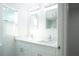 Bathroom featuring double vanity with stylish mirrors and lighting at 5510 12Th St, Zephyrhills, FL 33542