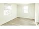 This bedroom features wood-look flooring and two windows for natural light at 5510 12Th St, Zephyrhills, FL 33542