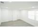 All-white bedroom featuring two doors and bright natural light at 5510 12Th St, Zephyrhills, FL 33542