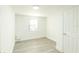 Bright bedroom with wood-look floors, white walls, and a window for ample natural light at 5510 12Th St, Zephyrhills, FL 33542