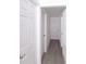 This hallway features wood-look flooring and doors at 5510 12Th St, Zephyrhills, FL 33542