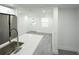 A stainless steel fridge accents the kitchen island with white counters and stainless steel faucet at 5510 12Th St, Zephyrhills, FL 33542