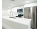 Bright kitchen with white cabinetry, stainless steel appliances, and a large center island at 5510 12Th St, Zephyrhills, FL 33542