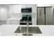Close-up of a kitchen island with white counters and a stainless steel faucet at 5510 12Th St, Zephyrhills, FL 33542
