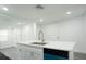 Kitchen island with white countertop and a stainless steel faucet, in a well lit kitchen at 5510 12Th St, Zephyrhills, FL 33542