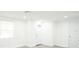 Bright living room with all-white interior and grey wood-look floors at 5510 12Th St, Zephyrhills, FL 33542